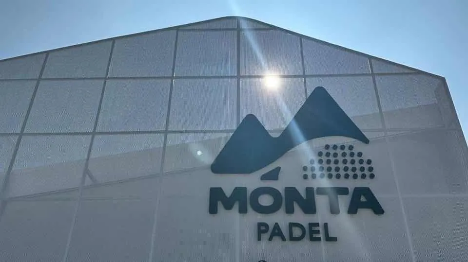 The Monta Padel mark on the building's pale façade against a blue sky