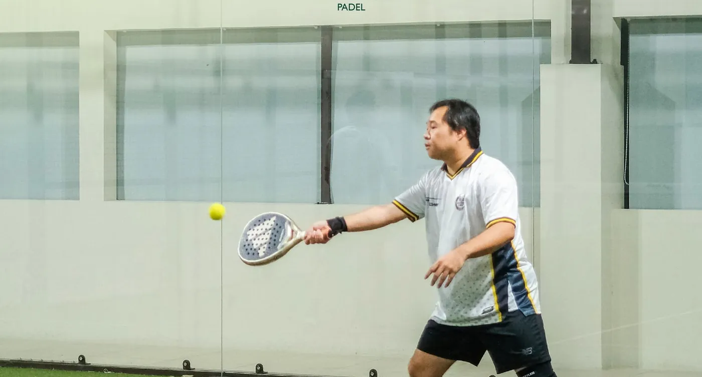 A player stretching for a forehand on a Monta court